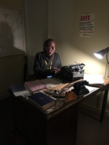 Bongo Man sitting at Alan Turing's desk